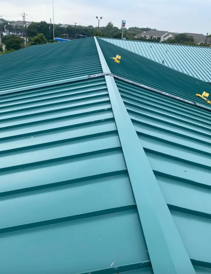 Green commercial metal roof ridge and valley for Metal Roof Repair in Ashburnham